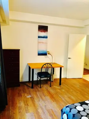 a desk in a room with a table and a chair at Stylish Montreal Apartment: Comfortable Stay in the Golden Square Mile in Montréal