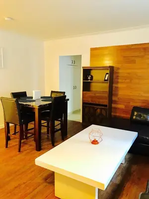 a living room with a table and chairs at Stylish Montreal Apartment: Comfortable Stay in the Golden Square Mile in Montréal