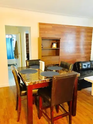 a dining room with a table with chairs and a couch at Stylish Montreal Apartment: Comfortable Stay in the Golden Square Mile in Montréal
