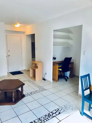 a living room with a table and a desk at Stylish Montreal Apartment: Comfortable Stay in the Golden Square Mile in Montréal