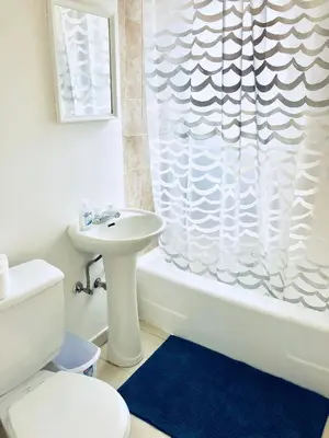 a bathroom with a sink and a shower curtain at Stylish Montreal Apartment: Comfortable Stay in the Golden Square Mile in Montréal