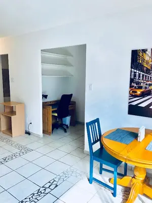 a room with a table and chairs and a desk at Stylish Montreal Apartment: Comfortable Stay in the Golden Square Mile in Montréal