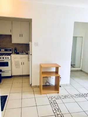 a kitchen with a stove and a table in it at Stylish Montreal Apartment: Comfortable Stay in the Golden Square Mile in Montréal
