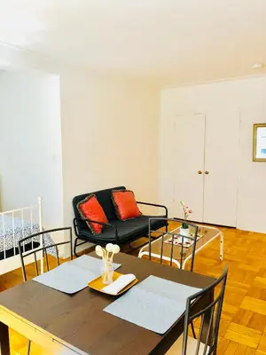 a living room with a table and a couch at Stylish Montreal Apartment: Comfortable Stay in the Golden Square Mile in Montréal