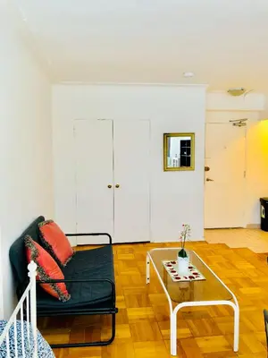 a living room with a couch and a table at Stylish Montreal Apartment: Comfortable Stay in the Golden Square Mile in Montréal
