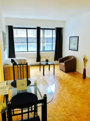a living room with a glass table and a couch at Stylish Montreal Apartment: Comfortable Stay in the Golden Square Mile in Montréal