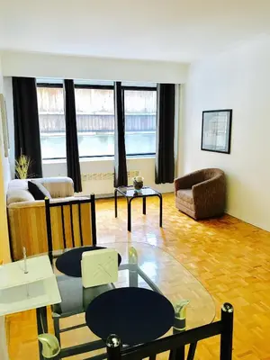 a living room with a couch and a table at Stylish Montreal Apartment: Comfortable Stay in the Golden Square Mile in Montréal