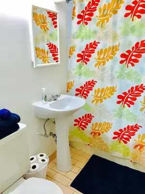a bathroom with a sink and a shower curtain at Stylish Montreal Apartment: Comfortable Stay in the Golden Square Mile in Montréal