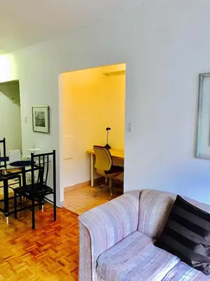 a living room with a couch and a table at Stylish Montreal Apartment: Comfortable Stay in the Golden Square Mile in Montréal