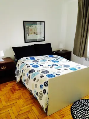 a bed with a comforter on it in a bedroom at Stylish Montreal Apartment: Comfortable Stay in the Golden Square Mile in Montréal