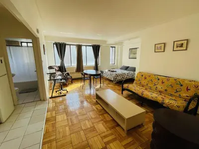 a living room with a couch and a table at Stylish Montreal Apartment: Comfortable Stay in the Golden Square Mile in Montréal