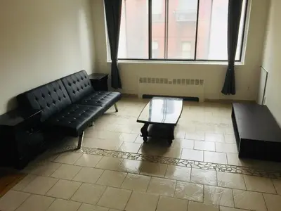 a living room with a couch and a coffee table at Stylish Montreal Apartment: Comfortable Stay in the Golden Square Mile in Montréal