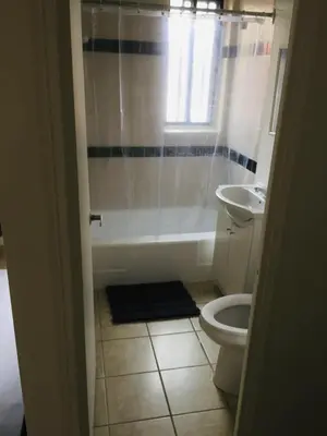 a bathroom with a tub and a toilet and a sink at Stylish Montreal Apartment: Comfortable Stay in the Golden Square Mile in Montréal
