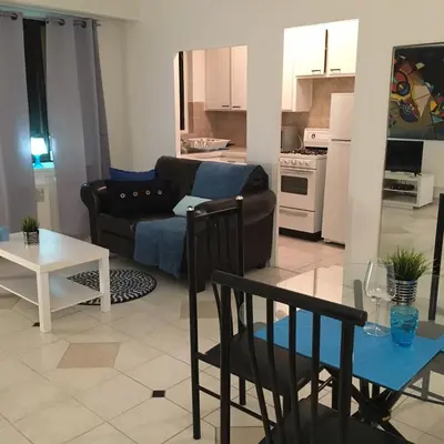 a living room with a couch and a table at Stylish Montreal Apartment: Comfortable Stay in the Golden Square Mile in Montréal