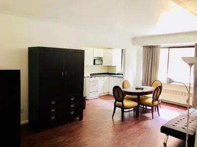 a kitchen and dining room with a table and chairs at Stylish Montreal Apartment: Comfortable Stay in the Golden Square Mile in Montréal