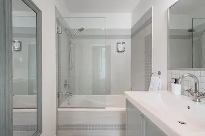 a white bathroom with a tub and a sink at Loft The White Pearl Plateau-Mont-Royal 3 Beds in Montréal