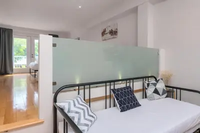 a bedroom with a bunk bed with two pillows on it at Loft The White Pearl Plateau-Mont-Royal 3 Beds in Montréal