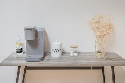 a table with a blender and a vase with flowers at Loft The White Pearl Plateau-Mont-Royal 3 Beds in Montréal