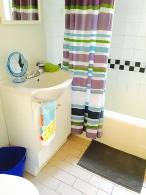 a bathroom with a sink and a shower curtain at Stylish Montreal Apartment: Comfortable Stay in the Golden Square Mile in Montréal