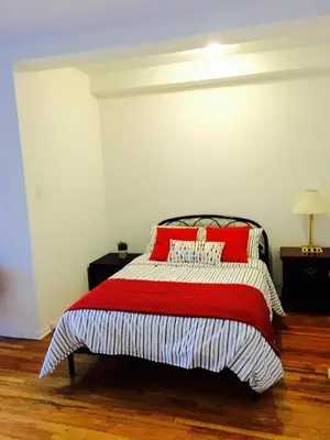 a bedroom with a bed with red pillows on it at Stylish Montreal Apartment: Comfortable Stay in the Golden Square Mile in Montréal