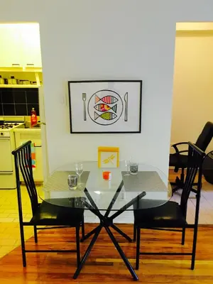 a glass table and two chairs in a kitchen at Stylish Montreal Apartment: Comfortable Stay in the Golden Square Mile in Montréal