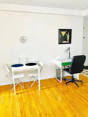 a room with a desk and a table and chairs at Stylish Montreal Apartment: Comfortable Stay in the Golden Square Mile in Montréal