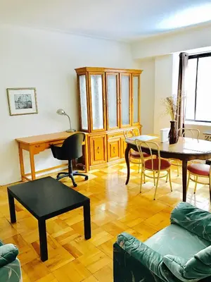 a living room with a couch and a table and chairs at Stylish Montreal Apartment: Comfortable Stay in the Golden Square Mile in Montréal