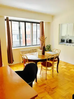 a dining room with a table and chairs at Stylish Montreal Apartment: Comfortable Stay in the Golden Square Mile in Montréal