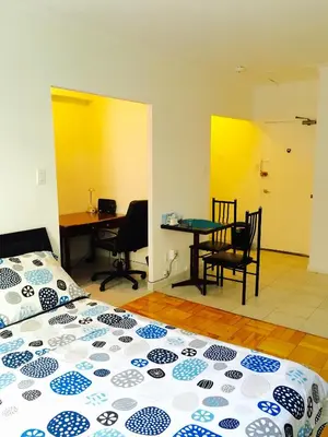 a bedroom with a bed and a table and chairs at Stylish Montreal Apartment: Comfortable Stay in the Golden Square Mile in Montréal