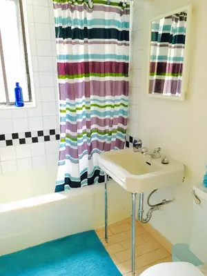 a bathroom with a sink and a shower curtain at Stylish Montreal Apartment: Comfortable Stay in the Golden Square Mile in Montréal