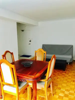 a dining room with a table and chairs and a bed at Stylish Montreal Apartment: Comfortable Stay in the Golden Square Mile in Montréal