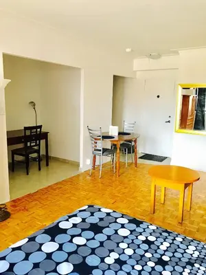 a living room with a table and chairs at Stylish Montreal Apartment: Comfortable Stay in the Golden Square Mile in Montréal