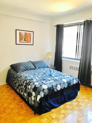 a bedroom with a bed and a large window at Stylish Montreal Apartment: Comfortable Stay in the Golden Square Mile in Montréal