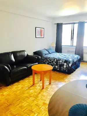 a living room with a couch and a table at Stylish Montreal Apartment: Comfortable Stay in the Golden Square Mile in Montréal