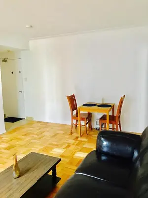 a living room with a table and chairs at Stylish Montreal Apartment: Comfortable Stay in the Golden Square Mile in Montréal