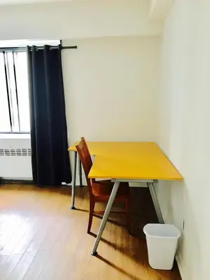 a wooden table with a chair in a room at Stylish Montreal Apartment: Comfortable Stay in the Golden Square Mile in Montréal