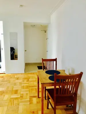 a dining room with a table and two chairs at Stylish Montreal Apartment: Comfortable Stay in the Golden Square Mile in Montréal