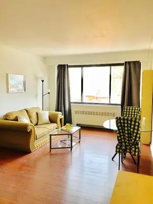 a living room with a couch and a table at Stylish Montreal Apartment: Comfortable Stay in the Golden Square Mile in Montréal