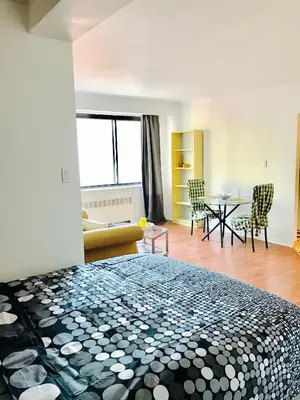 a bedroom with a bed and a table and chairs at Stylish Montreal Apartment: Comfortable Stay in the Golden Square Mile in Montréal