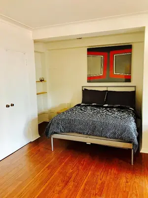 a bedroom with a bed and a painting on the wall at Stylish Montreal Apartment: Comfortable Stay in the Golden Square Mile in Montréal