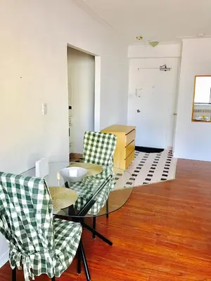 a living room with two chairs and a glass table at Stylish Montreal Apartment: Comfortable Stay in the Golden Square Mile in Montréal