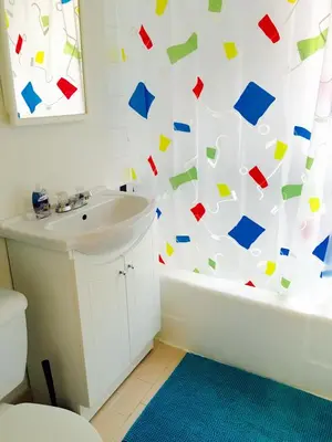 a bathroom with a shower curtain covered in confetti at Stylish Montreal Apartment: Comfortable Stay in the Golden Square Mile in Montréal