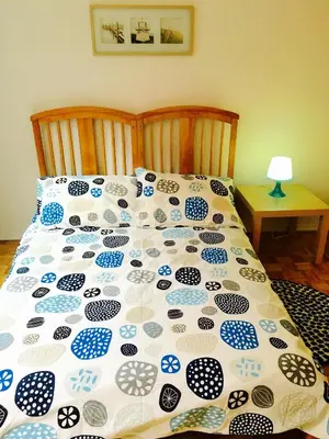 a bed with a blue and white comforter on it at Stylish Montreal Apartment: Comfortable Stay in the Golden Square Mile in Montréal