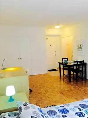 a living room with a table and a dining room at Stylish Montreal Apartment: Comfortable Stay in the Golden Square Mile in Montréal