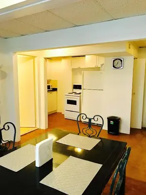 a kitchen with a black table and chairs in a room at Stylish Montreal Apartment: Comfortable Stay in the Golden Square Mile in Montréal