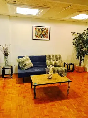 a living room with a blue couch and a coffee table at Stylish Montreal Apartment: Comfortable Stay in the Golden Square Mile in Montréal