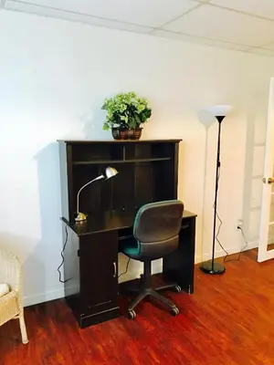an office with a desk with a chair and a lamp at Stylish Montreal Apartment: Comfortable Stay in the Golden Square Mile in Montréal