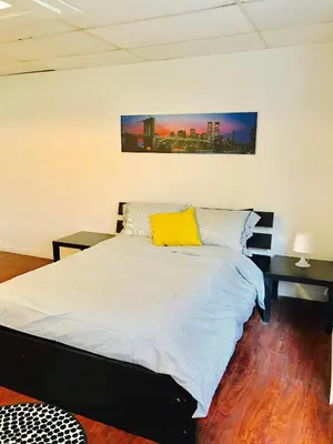 a bedroom with a bed with a yellow pillow on it at Stylish Montreal Apartment: Comfortable Stay in the Golden Square Mile in Montréal