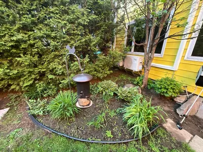 a garden with a fire hydrant in front of a house at L'Oasis Des Nomades in Trois-Rivières