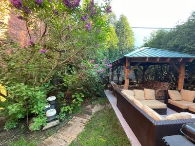 a gazebo with a couch in a garden at L'Oasis Des Nomades in Trois-Rivières